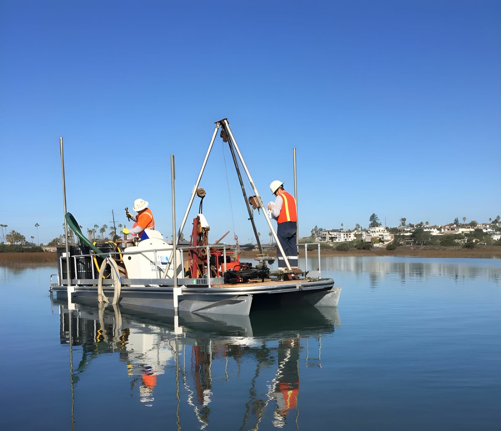 A Pacific Drilling crew working from a platform over a coastal lagoon